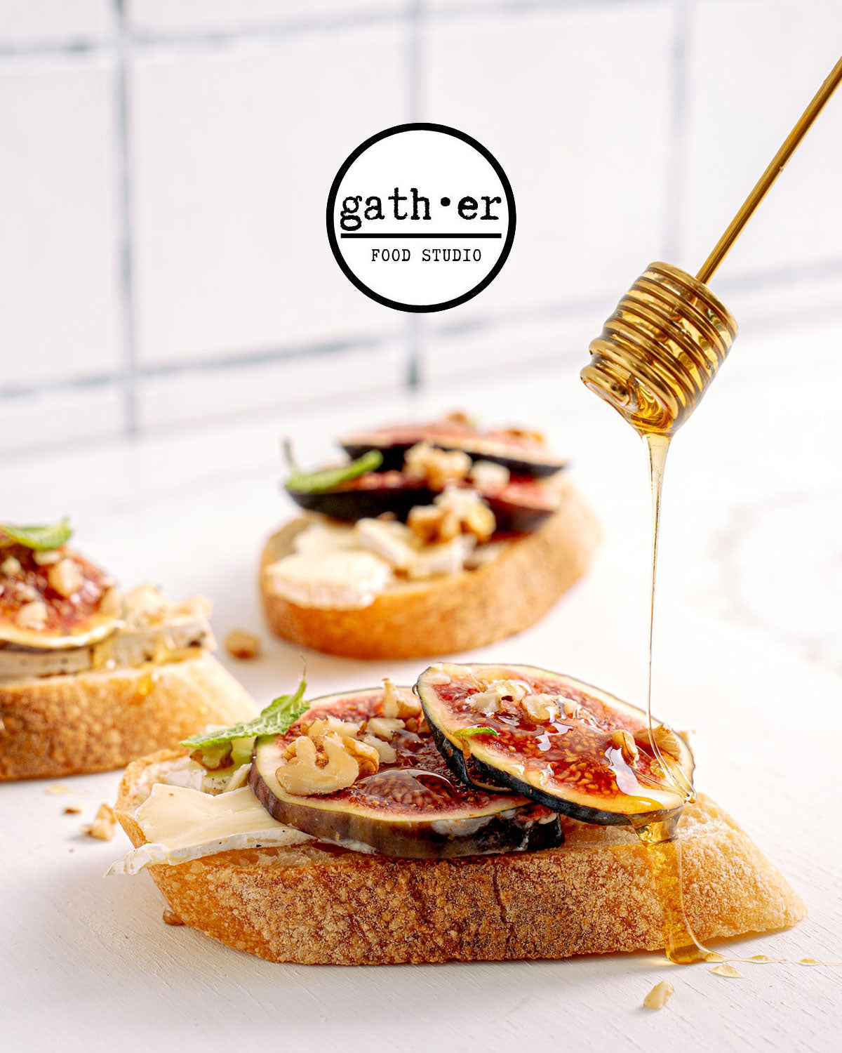 fig and brie cheese on a piece of bread with honey drizzled over top 